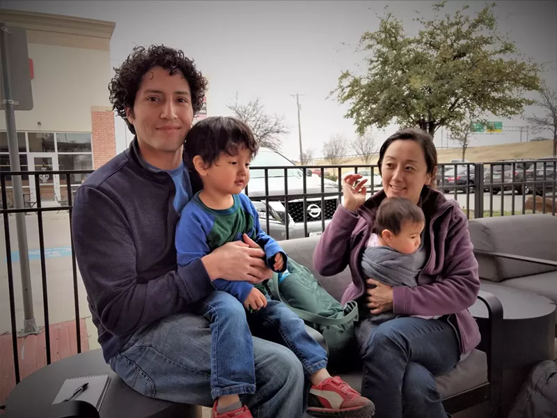 Image: Dr. Alan Romero, 2-year-old Luca in his lap, and Dr. Allis Cho holding 7-month-old Lyla.