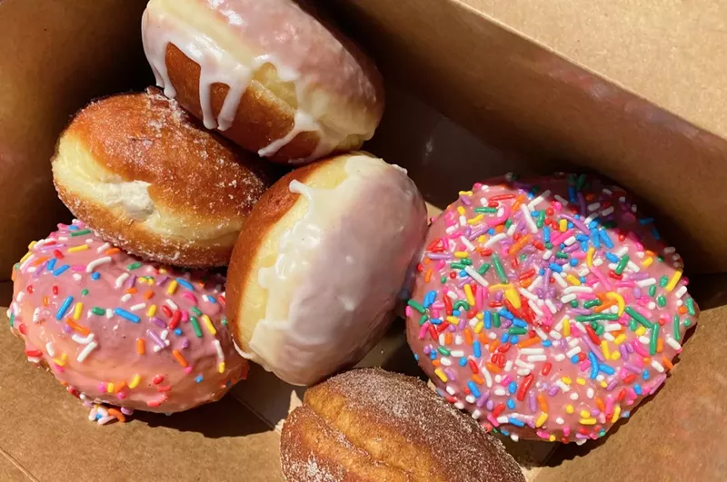 Image: A box of malasadas from B. doughnut, including the Homer. Guess which one is the Homer.