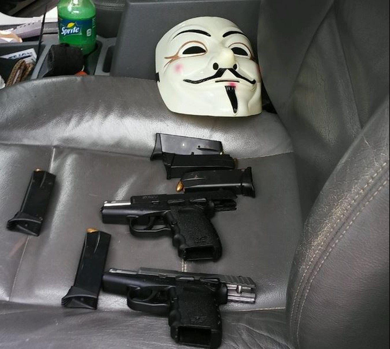 The handguns and Guy Fawkes mask inside the Durango.