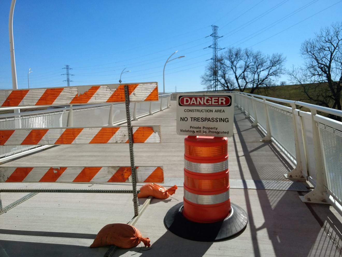 Signs warn that anyone entering the bridge will be prosecuted.