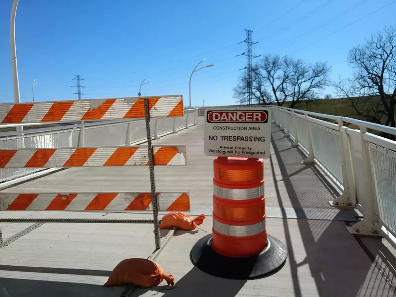 Image: Signs warn that anyone entering the bridge will be prosecuted.