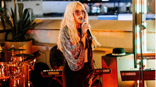 A woman hosting an open mic