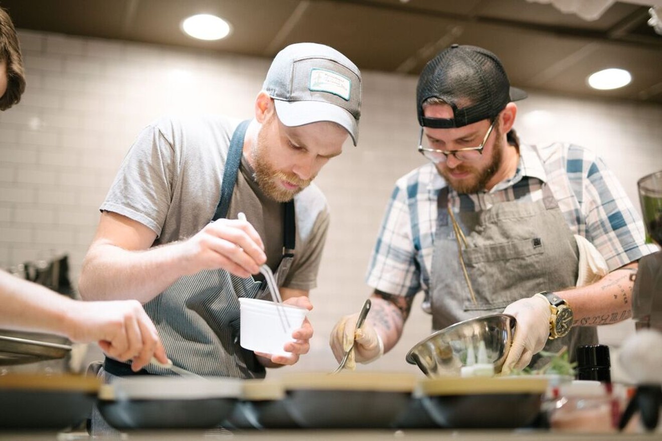 Jeremy Hess and Josh Farrell cook together at the farmer-focused spring pop-up dinner at Trio Craft Coffee.