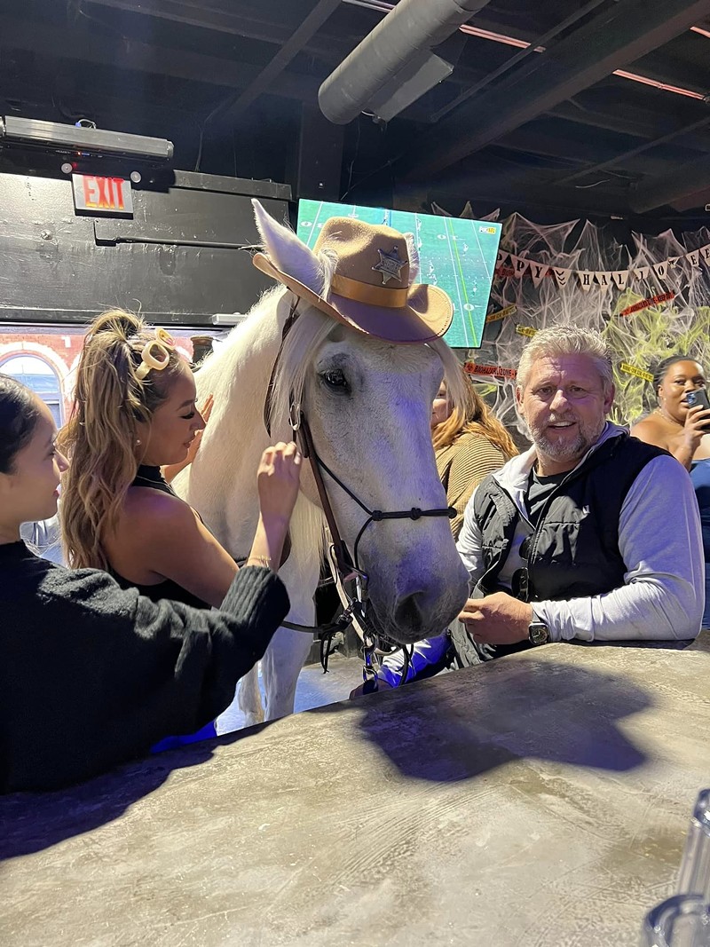 Michael Duncan of Fort Worth (right) and his horse, Sheriff the Bar Horse, mosey into the Rodeo Bar on Commerce Street.