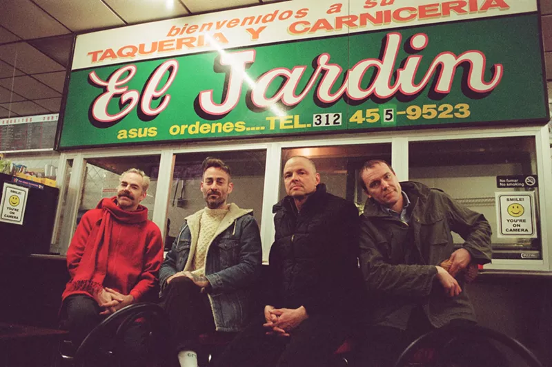 Image: This is a photo of guys standing in front of a restaurant.
