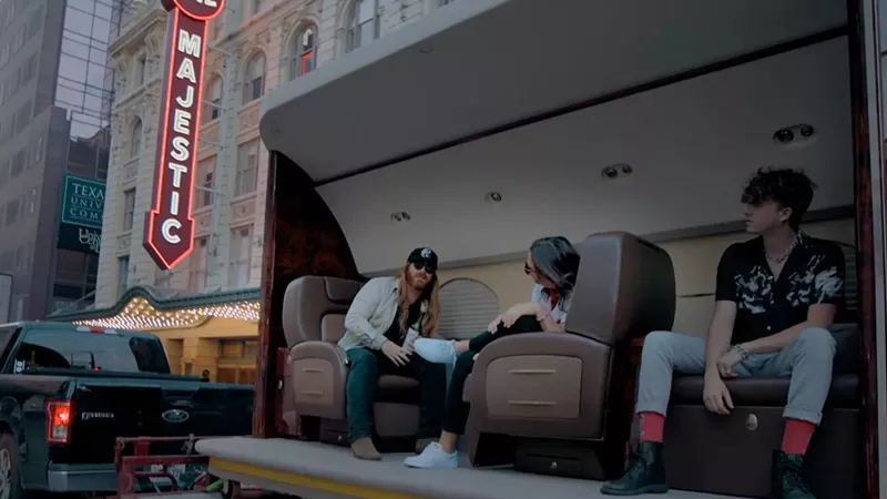 Image: Dallas singer Mitchell Ferguson, left, and Drugstore Cowboy's Carter Davis, center, and Grant Thompson, right, tooled around town in a hollowed-out plane fuselage for the music video "Dramatic," the second single from the group's collab album Maverick.
