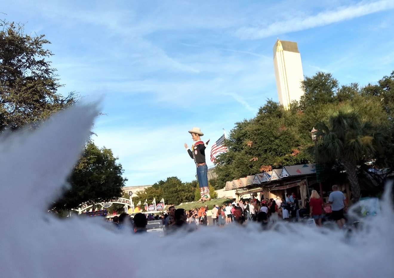 Big Tex, as seen over a half-eaten cone of cotton candy at the State Fair of Texas.