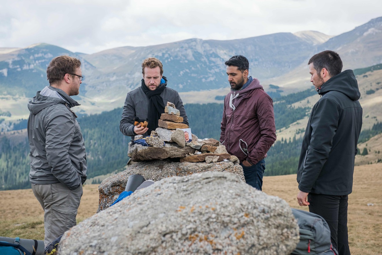 Four British lads played by (from left) Sam Troughton, Rafe Spall, Arsher Ali and Robert James-Collier hike through the deserted woods of northern Sweden before bashing open the door of a decrepit cabin to spend the night there in The Ritual.