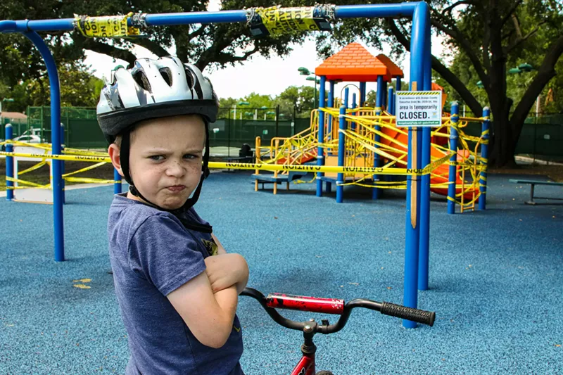 Image: angry kid on bike at playground