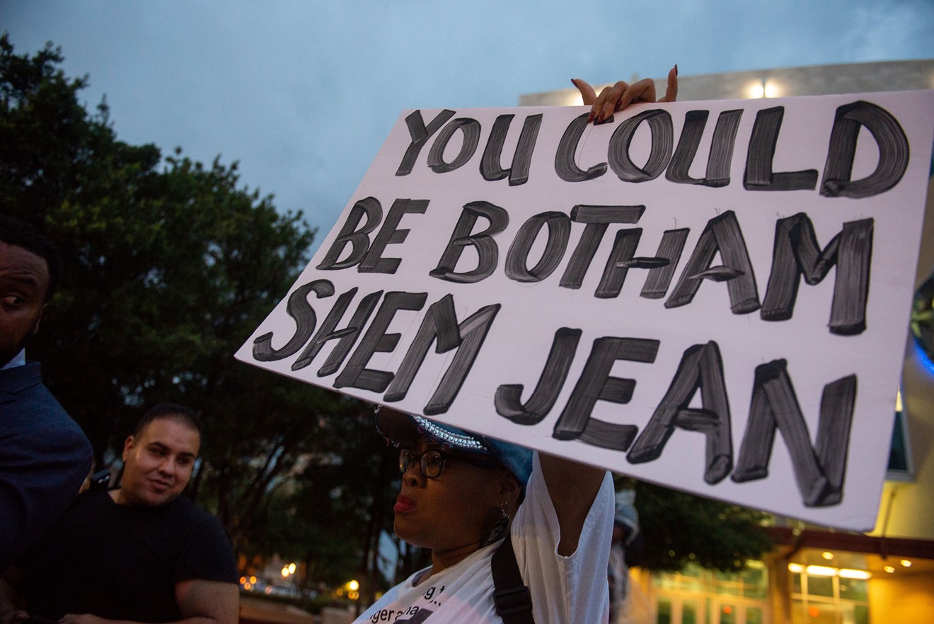 Demonstrators gather at a vigil for Botham Shem Jean at Dallas police headquarters.