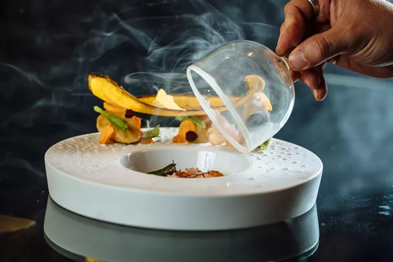 Image: Chef de cuisine Peter Barlow reveals a dish at Flora Street Cafe.