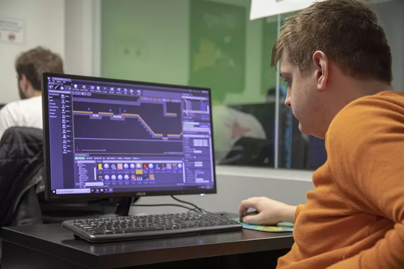 Image: Thomas Ward, a Crew designer of nonPareil Institute, works on his assignment, called a Quest, to test a video game level using game development program Unreal Engine.
