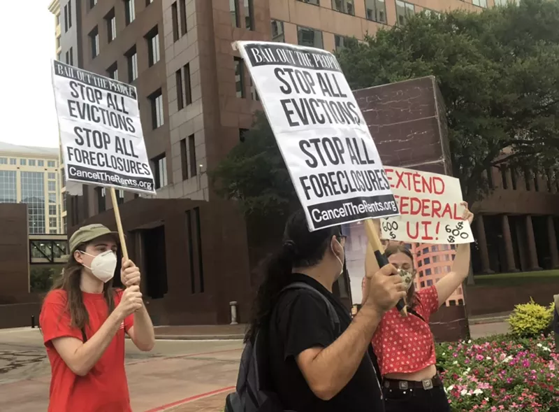 Image: North Texans gather outside U.S. Sen. John Cornyn's office building waving signs that read "Stop All Evictions" and "Let Us Live."