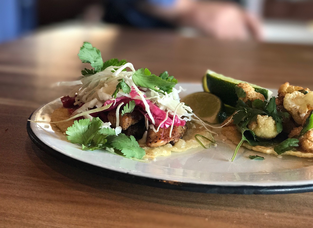 The pork belly taco with raw pickled cabbage, toasted sesame seed, cream and cilantro ($3.85).