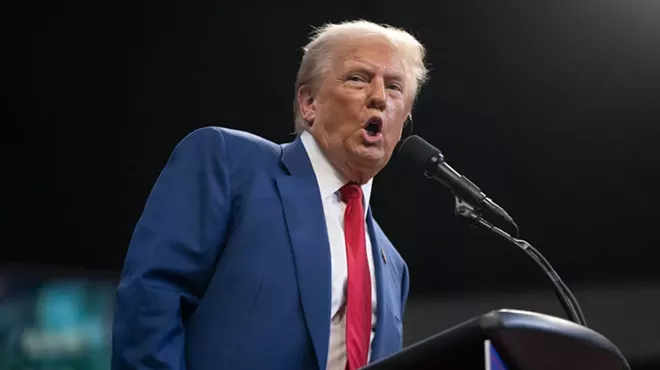 Donald Trump speaking into a microphone