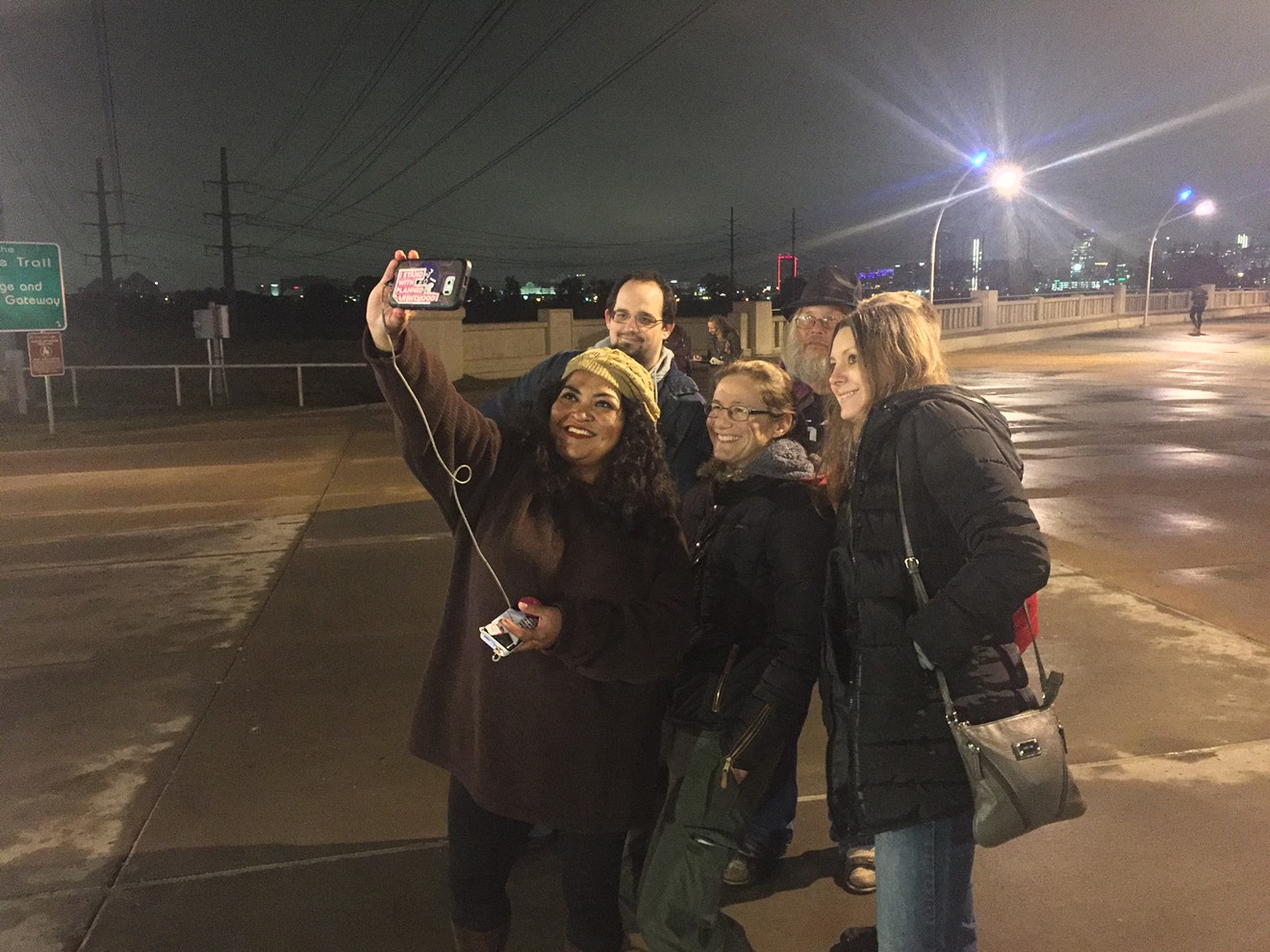 Soraya Colli of Dallas, the organizer of Wednesday night's event, takes a selfie of the group. The counterprotester, Zach, is top left.