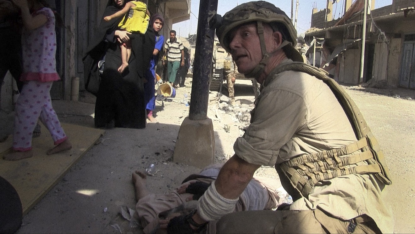 In a scene from the documentary Free Burma Rangers, David Eubank treats a wounded Iraqi in Mosul.