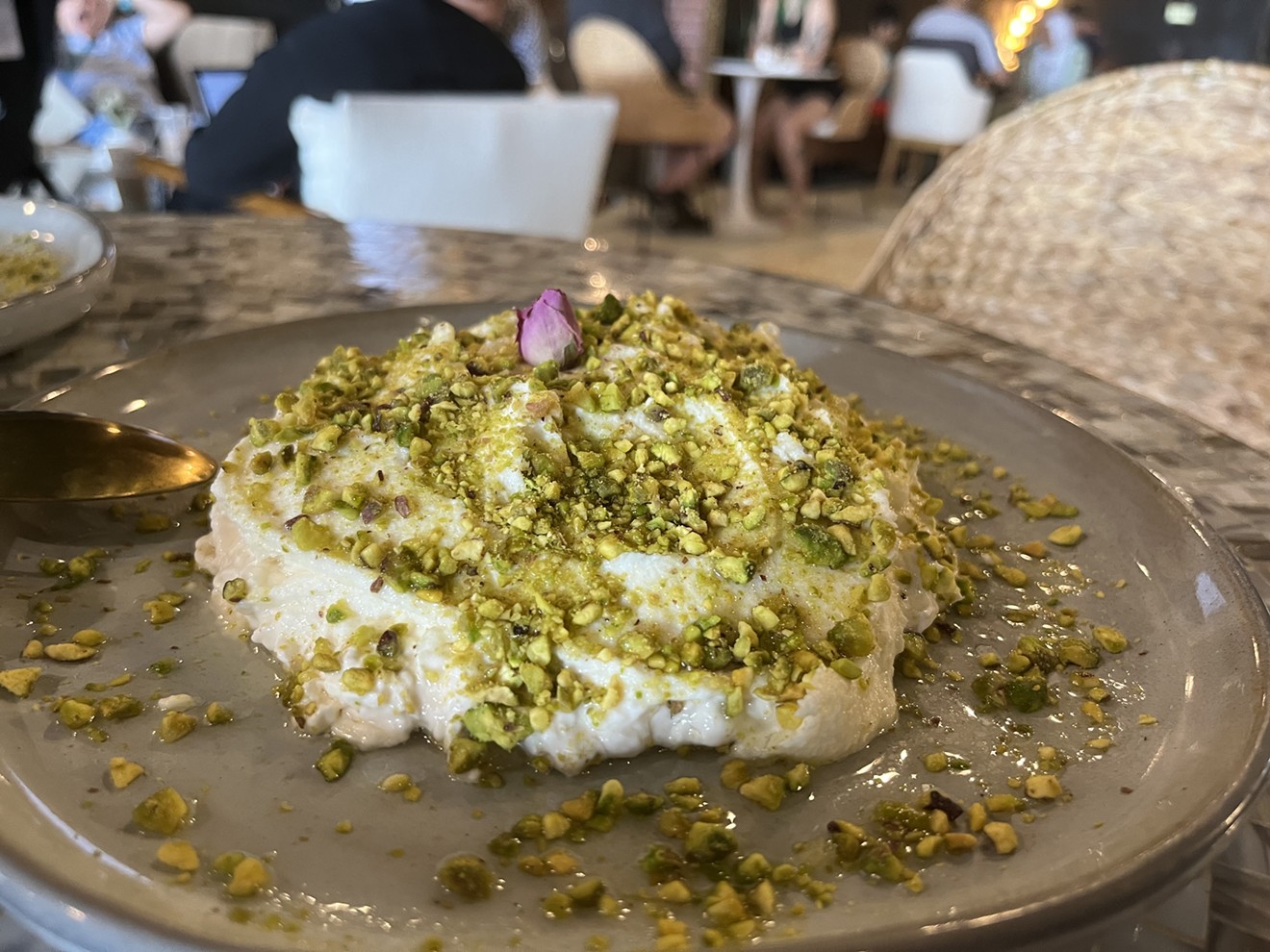 The house-special, Madluka, is a typical Syrian sweet that comes with a base of semolina pudding garnished with cream and pistachios.
