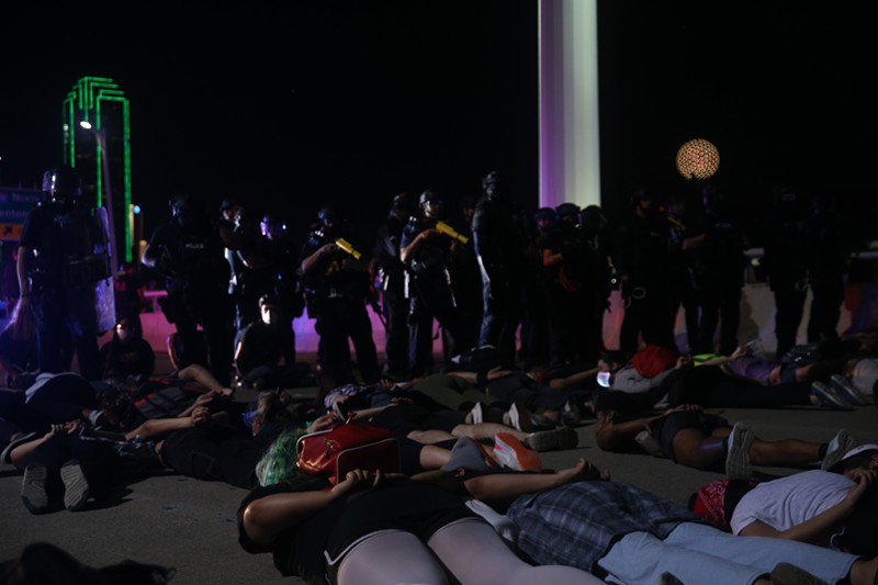 Protesters lie on their stomachs waiting to be arrested by police after marching on the Margaret Hunt Hill Bridge June 1.
