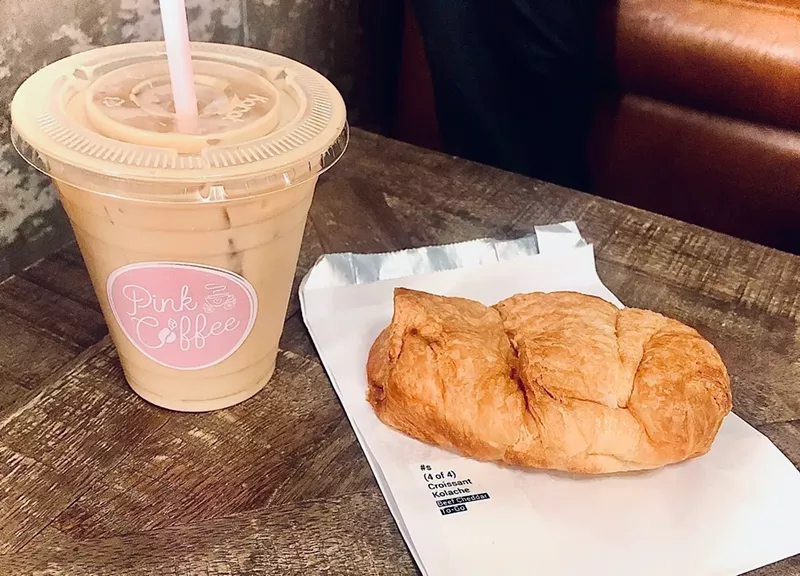 Image: lavender latte and sausage pastry.