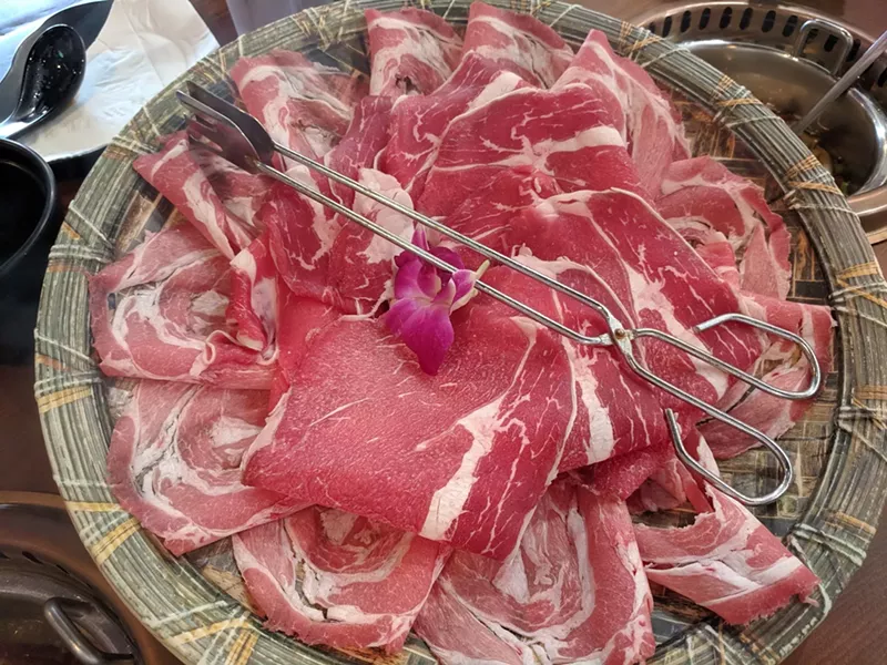 Image: A variety of beef and lamb at Chubby Cattle Conveyor Belt Hot Pot, served by human waiter, not by conveyor belt.