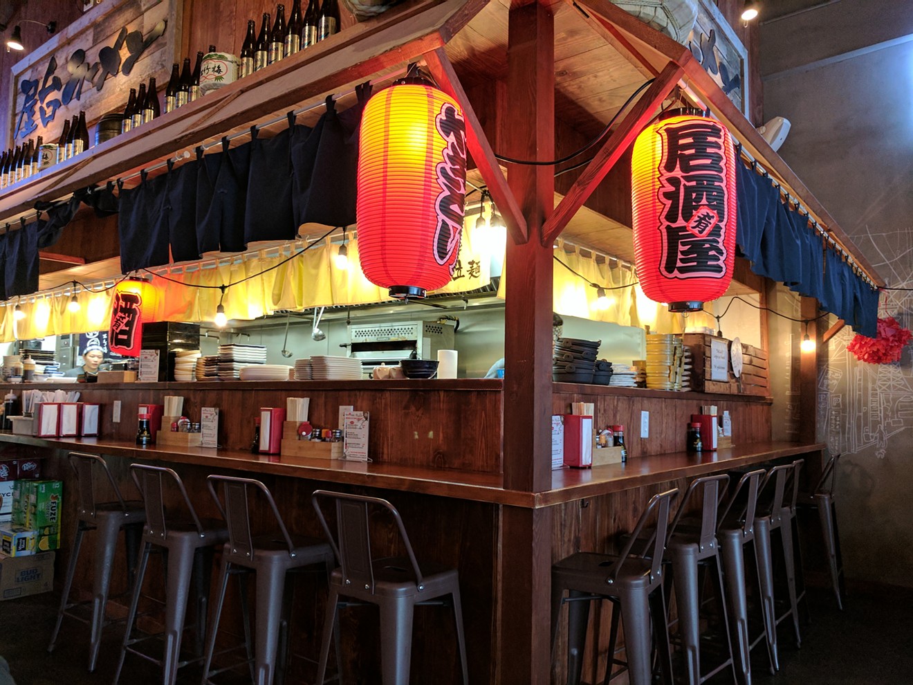 The appealing bar and open kitchen at Yatai Ramen Izakaya in Plano.