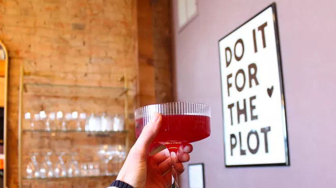 cocktail and sign at Plot Twist in Denton