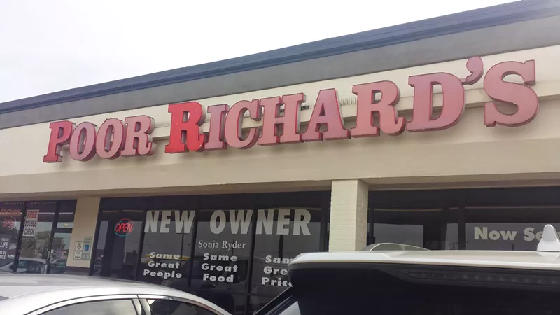 Image: Several signs in front of Poor Richard's Cafe in Plano prominently tout that the cafe has a new owner.