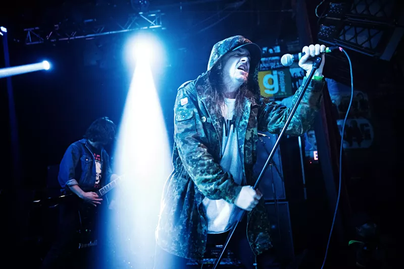 Image: Late Power Trip singer Riley Gale performs in a hoodie. The band is now playing No Values Festival in California.