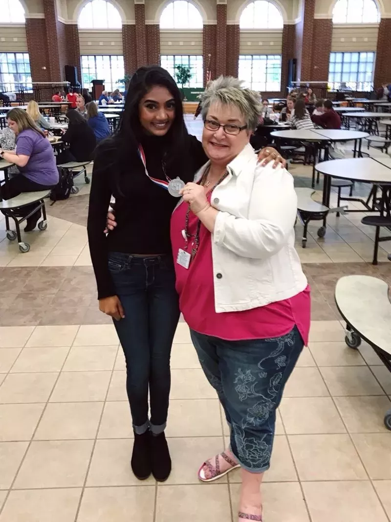 Image: Prosper High School journalism instructor Lori Oglesbee-Petter shows off the University Interscholastic League regional competition medal won by Neha Madhira, a senior at Prosper High School and editor-in-chief of the Eagle Nation Online student news website.