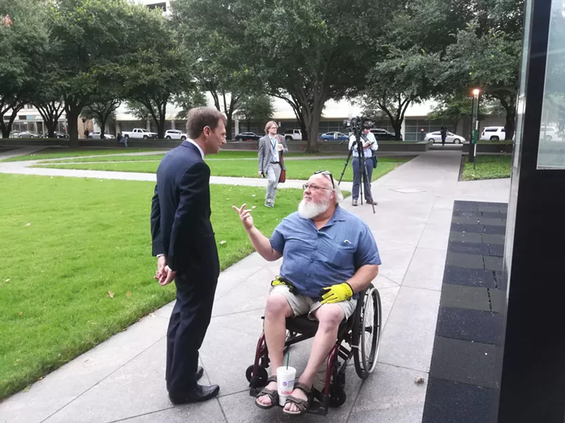 Image: Democratic candidate for Texas attorney general Justin Nelson talks to Michael Lummus ahead of Wednesday's Affordable Care Act hearing in Fort Worth.