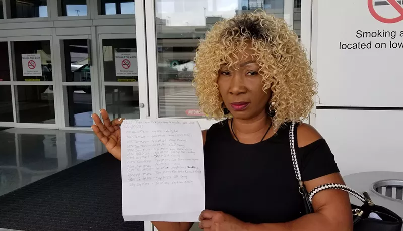 Image: Niameh Freeman, a salon owner in Euless, holds a list of 13 bank accounts Wells Fargo opened in her name without her knowledge.