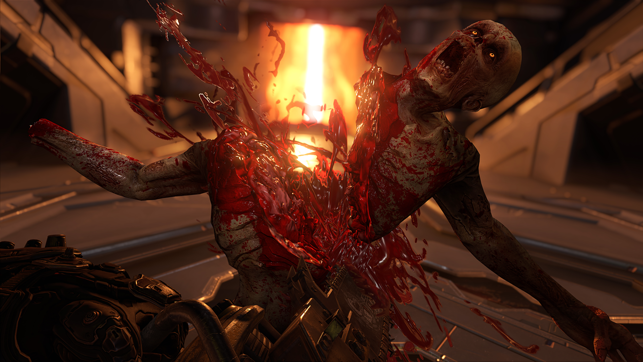 The Doomslayer cuts a member of the "Possessed" down the middle with his trusty chainsaw in DOOM Eternal, the fifth DOOM game from id Software and Bethesda Softworks coming to consoles and PCs in November.