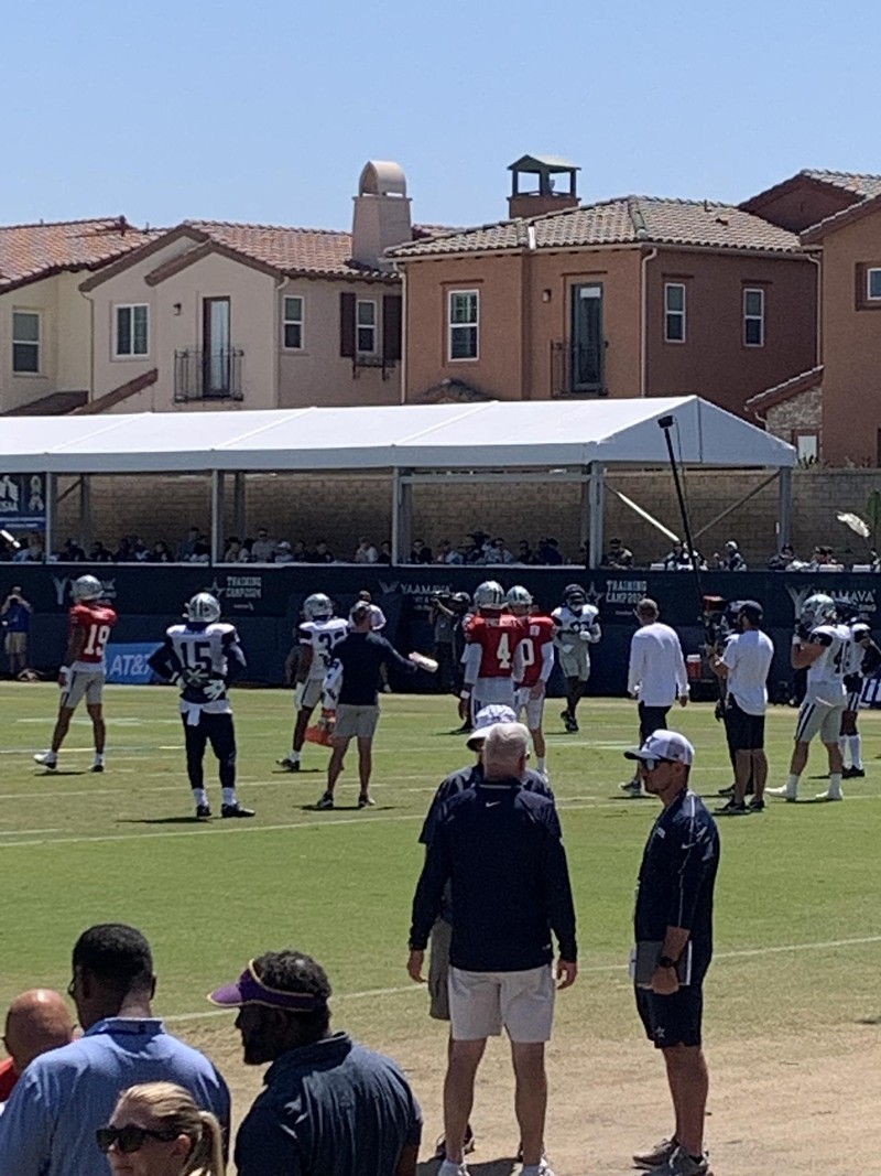 Dak Prescott (in red No. 4 jersey) practices with the Dallas Cowboys in Oxnard, California, in July 2024.