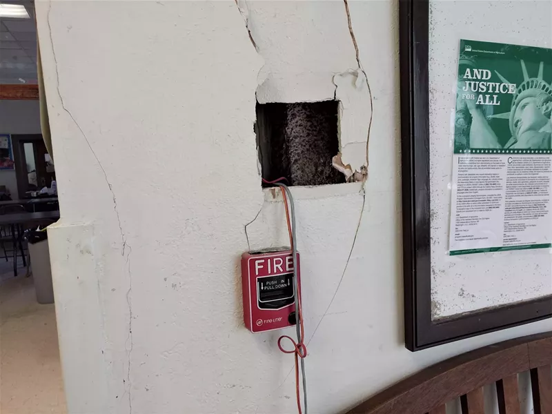 Image: Wiring hangs out of a hole in the wall at Pike Park Recreation Center.