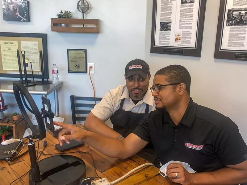 Image: Brothers Juan (left) and Brent Reaves produce a post for social media.