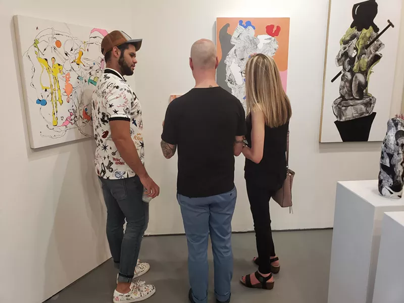 Image: Guests discussed the whimsical works of Jeanne C. Neal at Ro2 Gallery.