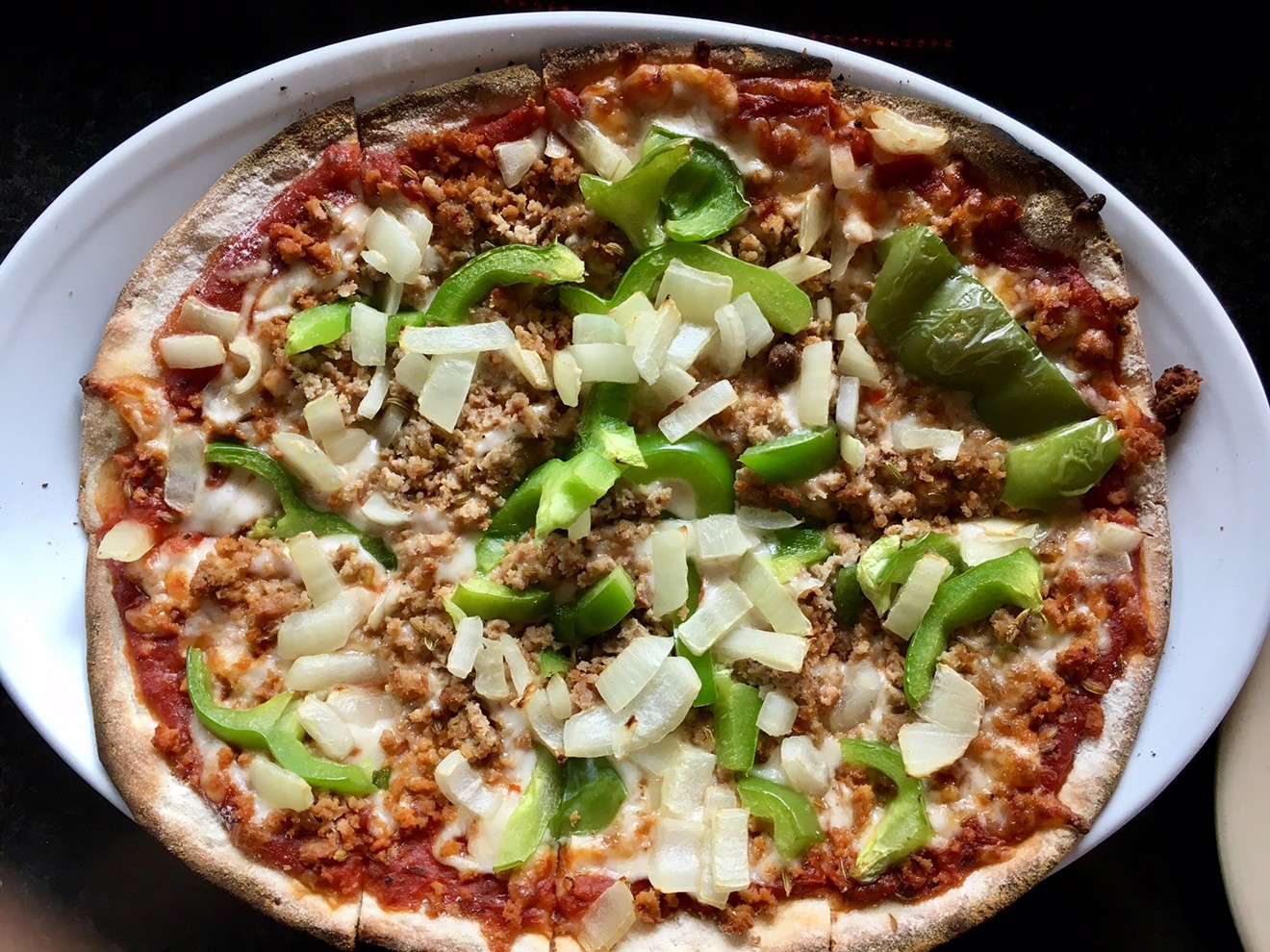 A drop-dead inexpensive pizza at Scalini's in Lakewood, with sausage, green pepper and onion.