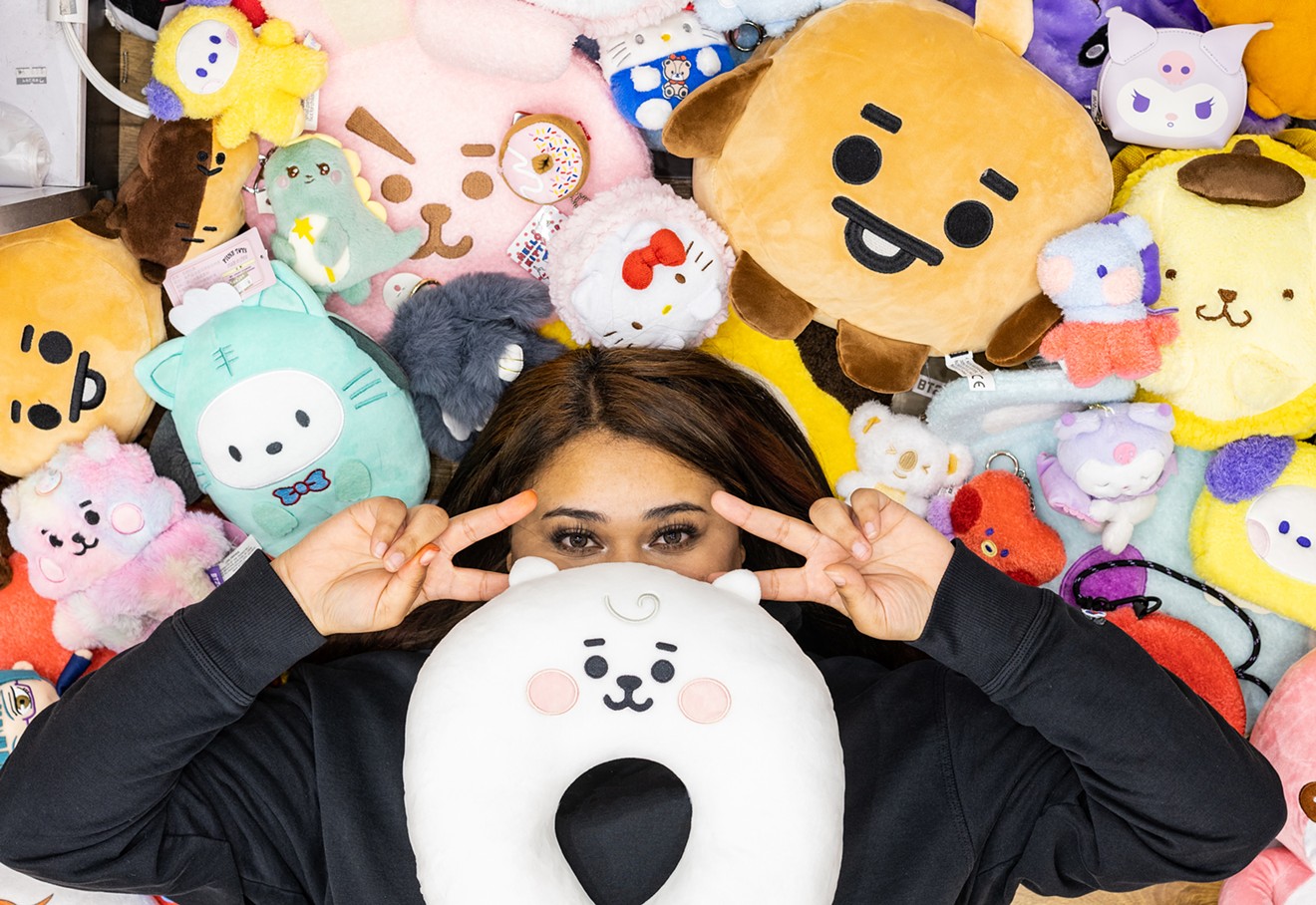Pink Box Manager Rose Miller poses with plushy merchandise at the Korean novelty store.