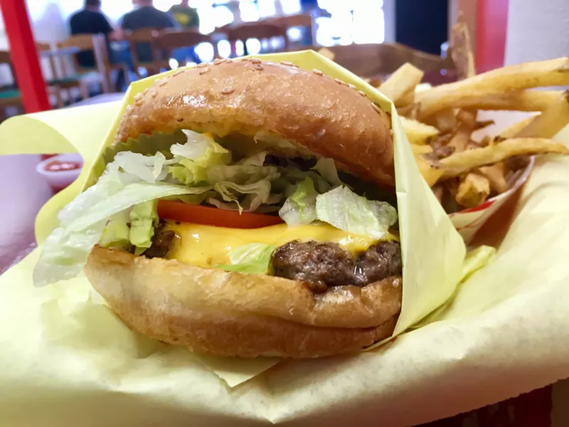 Image: The $5.19 cheeseburger with lettuce, tomato and pickle discs.