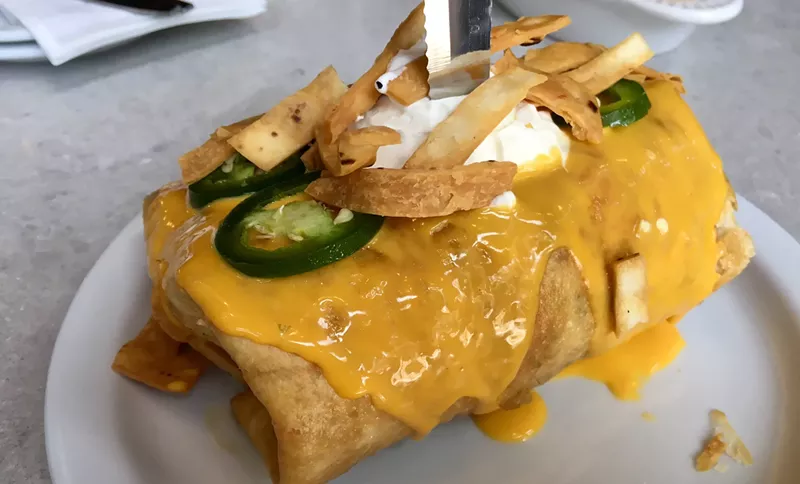 Image: Yes, there's a burger inside this deep-fried tortilla layered with cheese sauce, jalapeño slices and sour cream ($10.99).