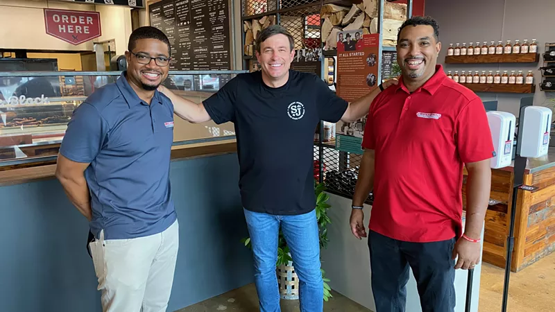 Image: Raising Cane's founder Todd Graves (center), pictured here with Brent Reaves (left) and Juan Reaves (right), made it his mission to help family-owned restaurants during the pandemic.