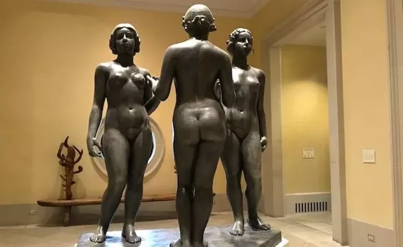 Image: View of the second-floor landing at the Meadows Museum, with Aristide Maillol’s "The Three Nymphs" (1930–38, cast 1939) in the foreground and James Surls’ "In Between" (1983) in the background.