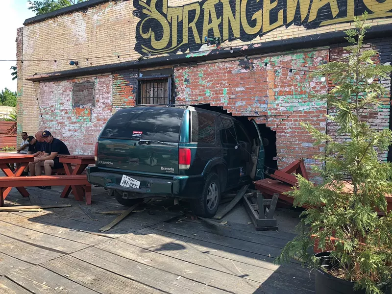 Image: Around 3:30 p.m. Sunday, an owner of Strangeways watched from the patio as an SUV crashed through the bar's wall.