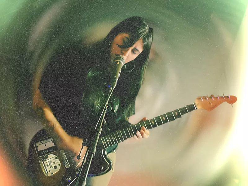 Image: Woman performing with a guitar