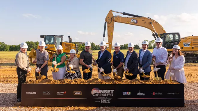 A group of people in front of dirt