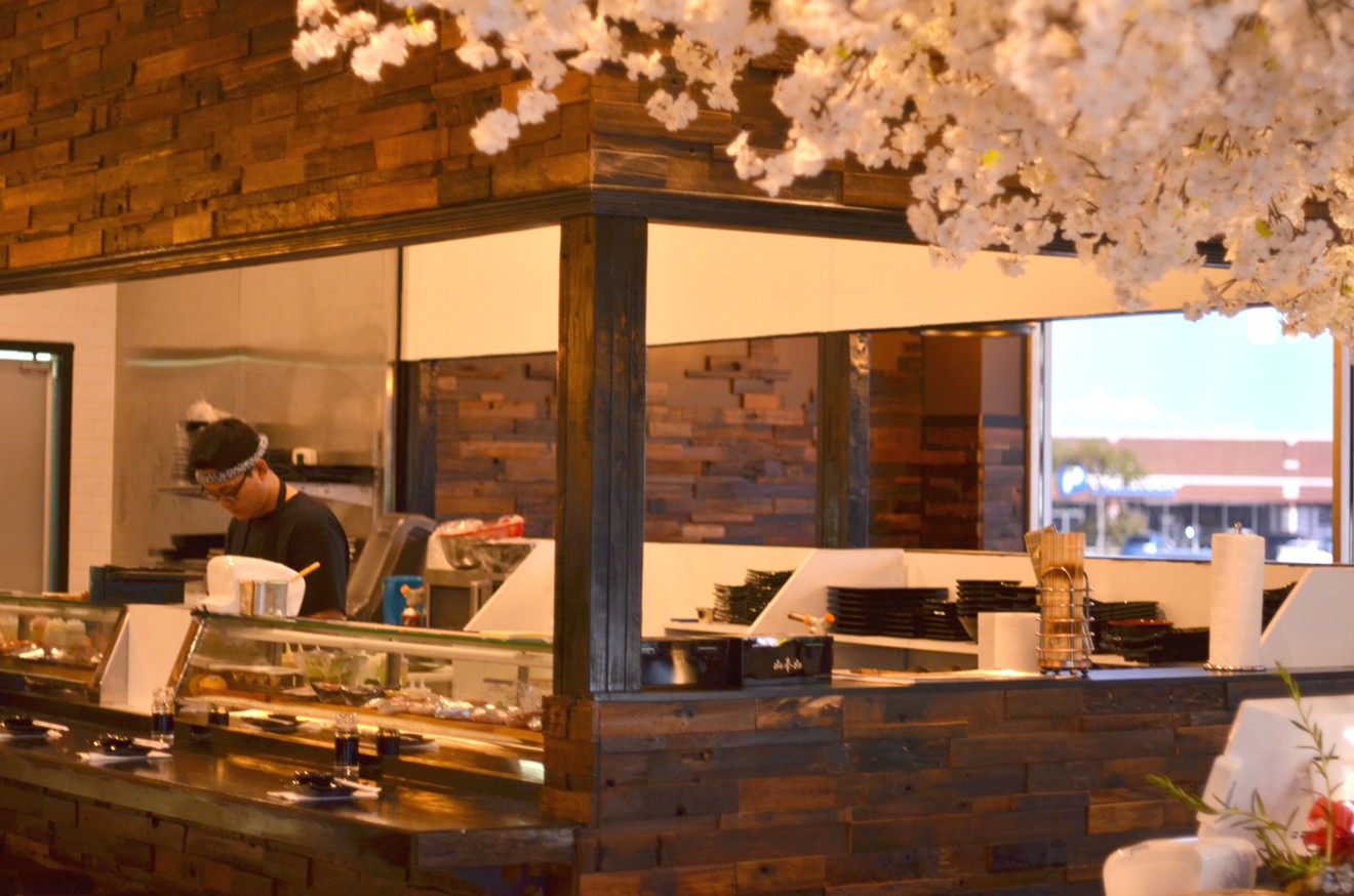 Sushi Kadan's interior is filled with leafy white faux cherry blossom trees.