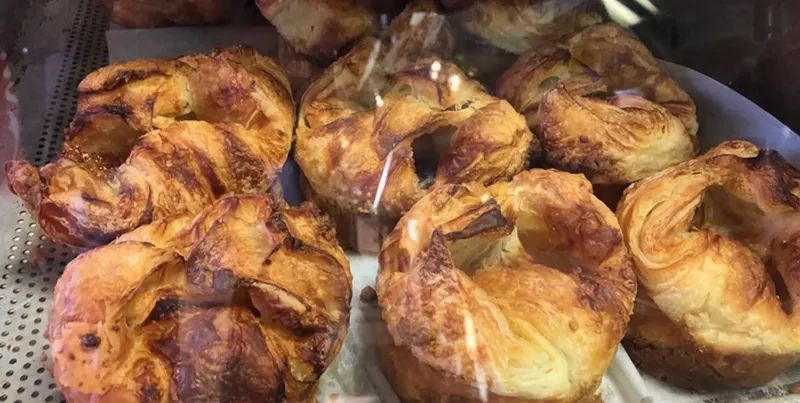 Image: Kouign-amanns basking in the case at Swiss Pastry Shop