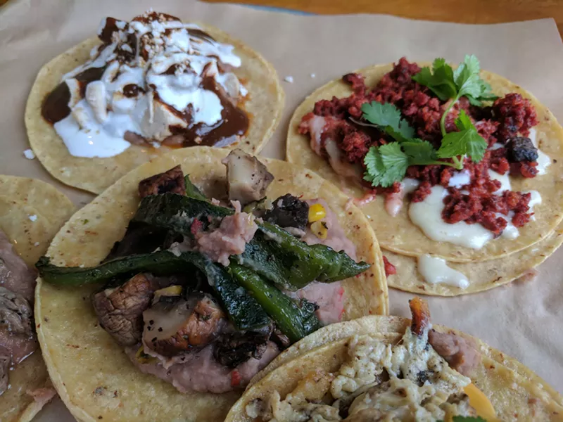 Image: A brunch taco sampler at Tacos Mariachi, including pollo en mole, choriqueso and rajas y portabello.