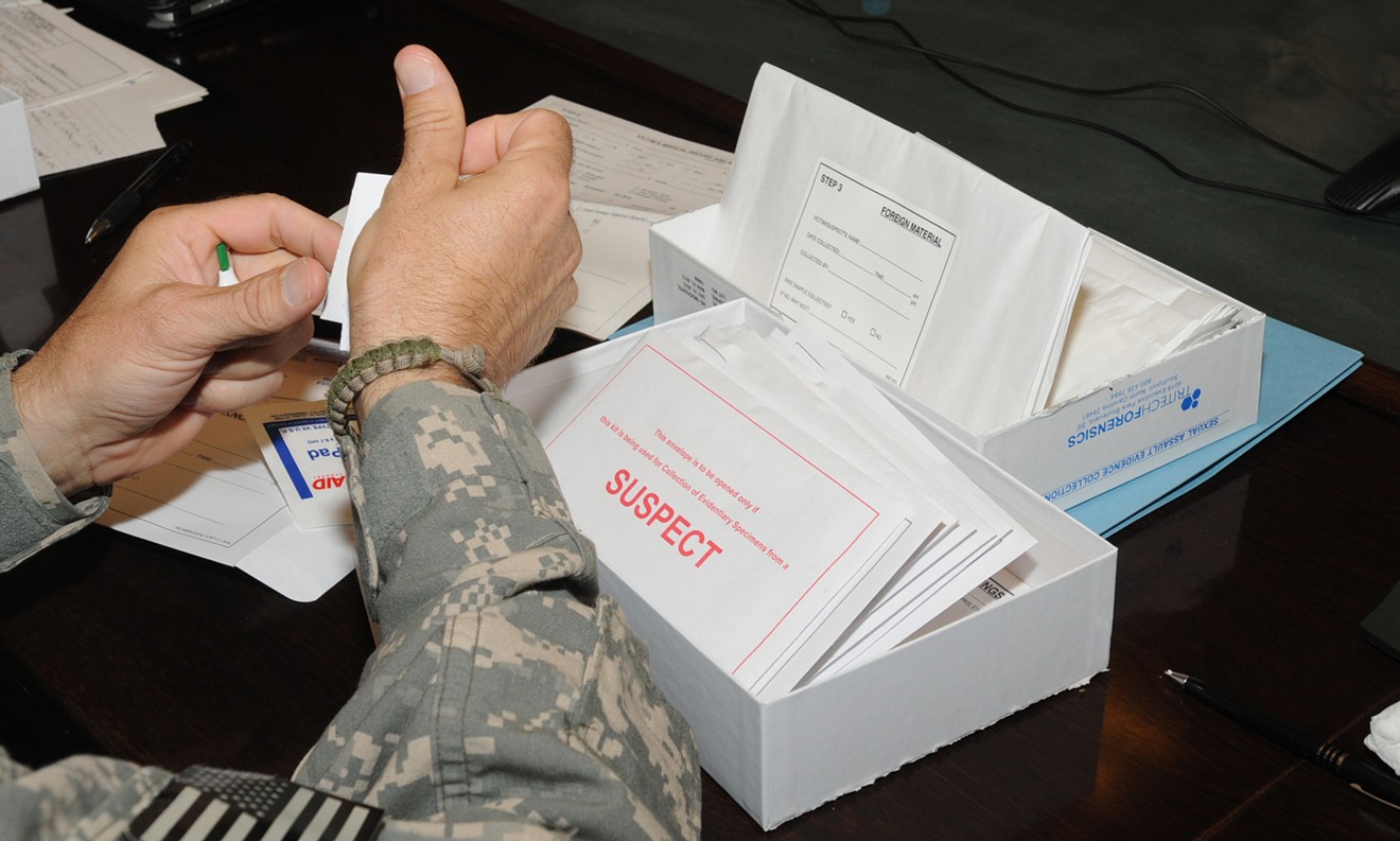 A U.S. military medical official learns how to use a sexual assault evidence collection kit in 2010.
